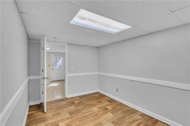 a view of a room with wooden floor and white walls