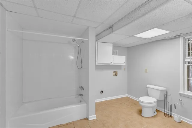 a bathroom with a sink vanity mirror and toilet