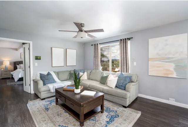 a living room with furniture and wooden floor