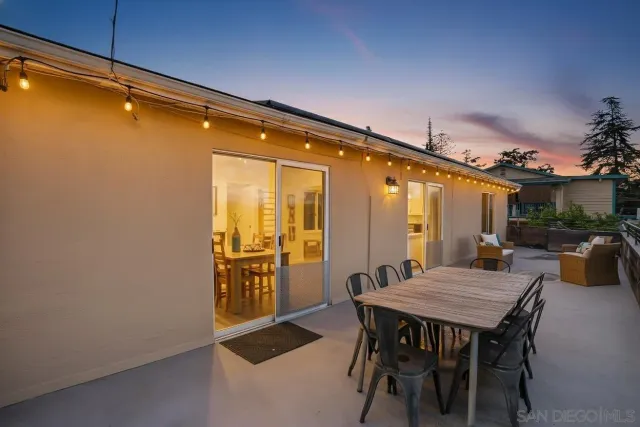 a outdoor space with a table and chairs