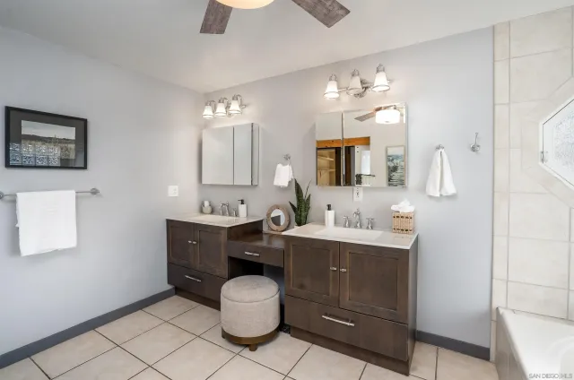a spacious bathroom with a double vanity sink mirror and