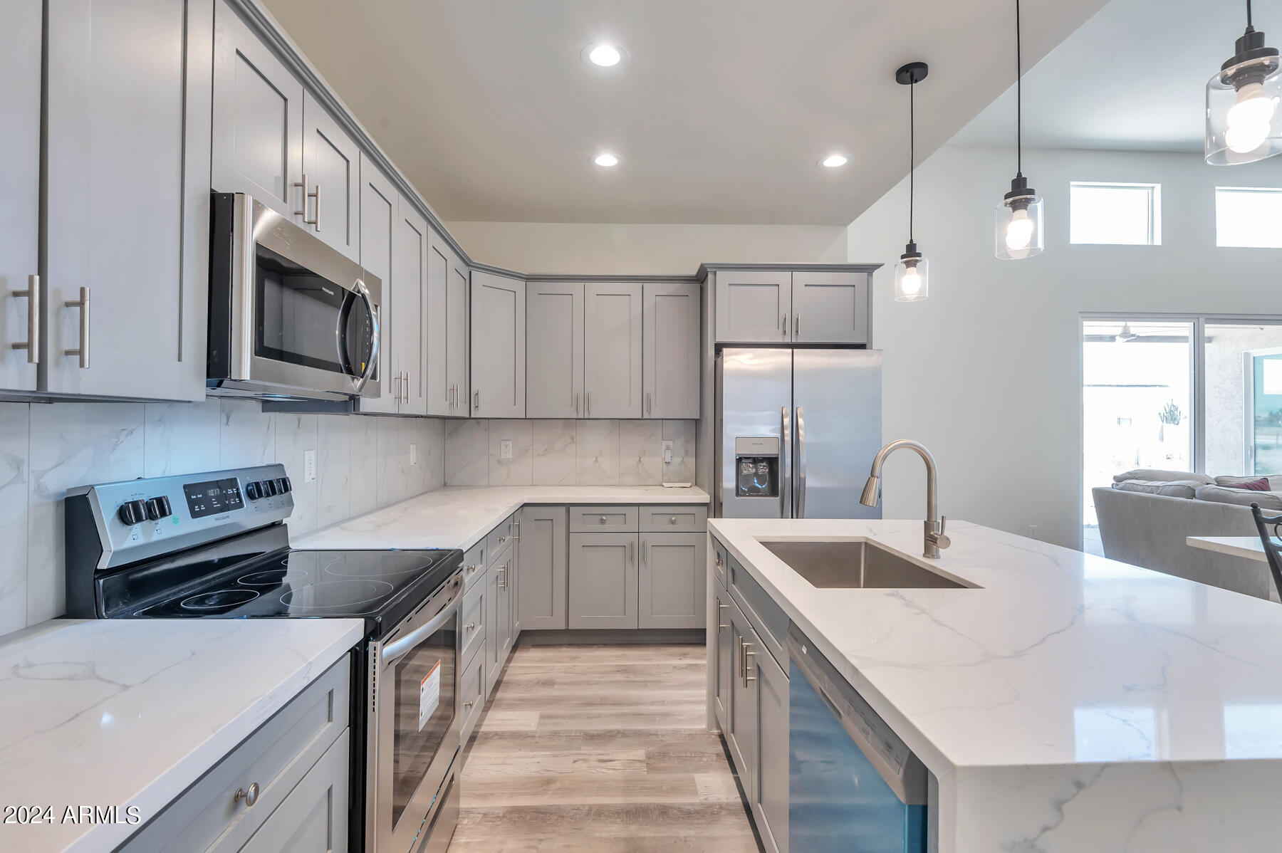 14825 Charco Road Arizona City, AZ 85123 - Photo 14 of 24 a kitchen with a sink a stove top oven and refrigerator