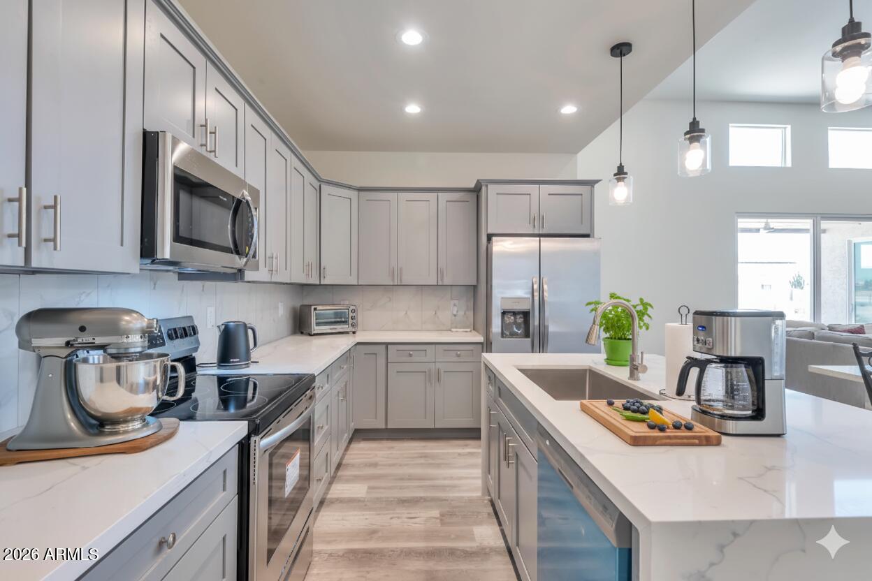 14825 Charco Road Arizona City, AZ 85123 - Photo 5 of 24 a kitchen with stainless steel appliances granite countertop a sink stove and refrigerator