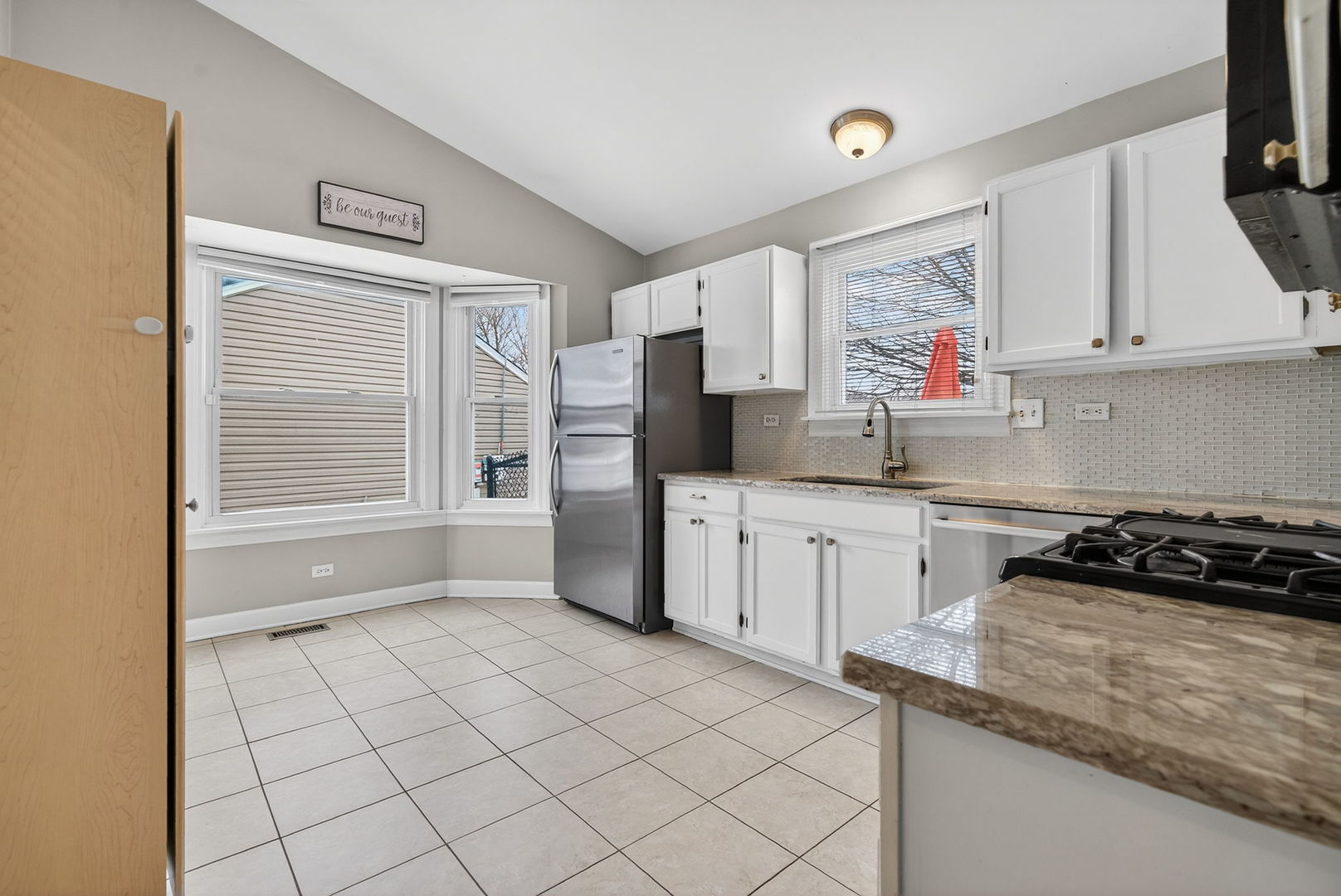 1412 Bar Harbour Road Aurora, IL 60504 - Photo 13 of 38 a kitchen with granite countertop a stove a sink and a refrigerator