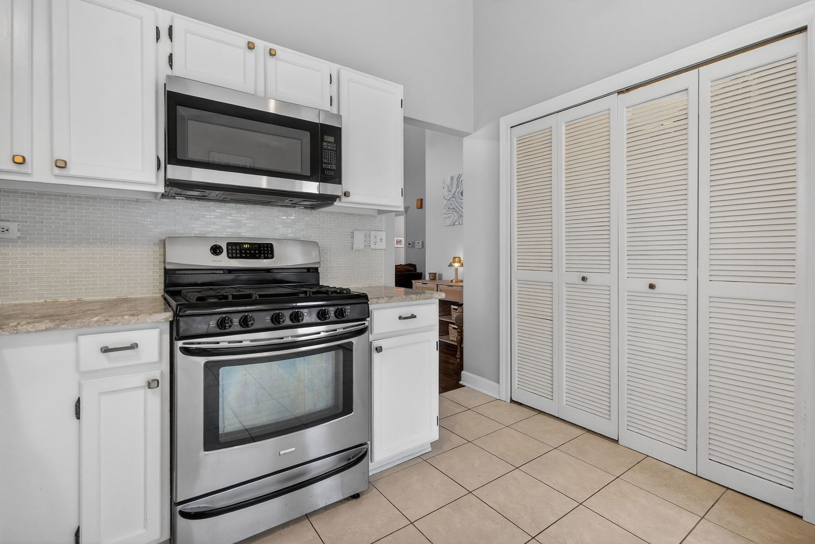 1412 Bar Harbour Road Aurora, IL 60504 - Photo 17 of 38 a kitchen with stainless steel appliances white cabinets a stove top oven a sink and dishwasher