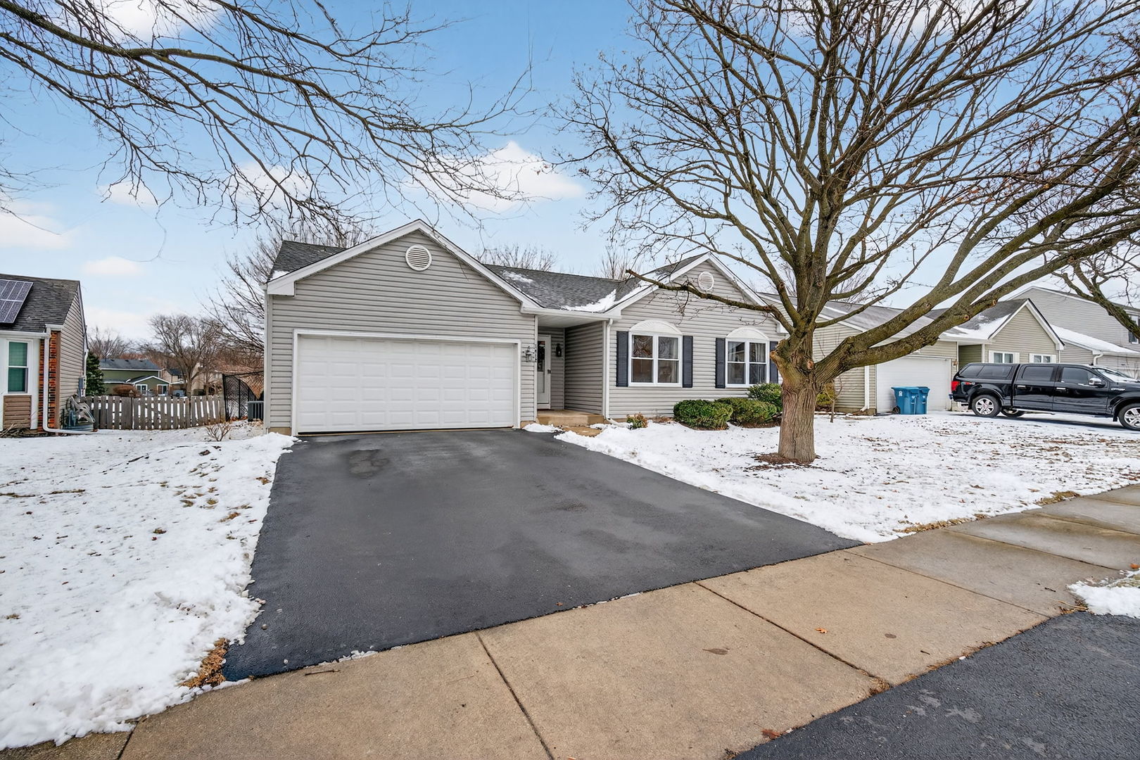 1412 Bar Harbour Road Aurora, IL 60504 - Photo 3 of 38 a front view of a house with a yard covered in snow