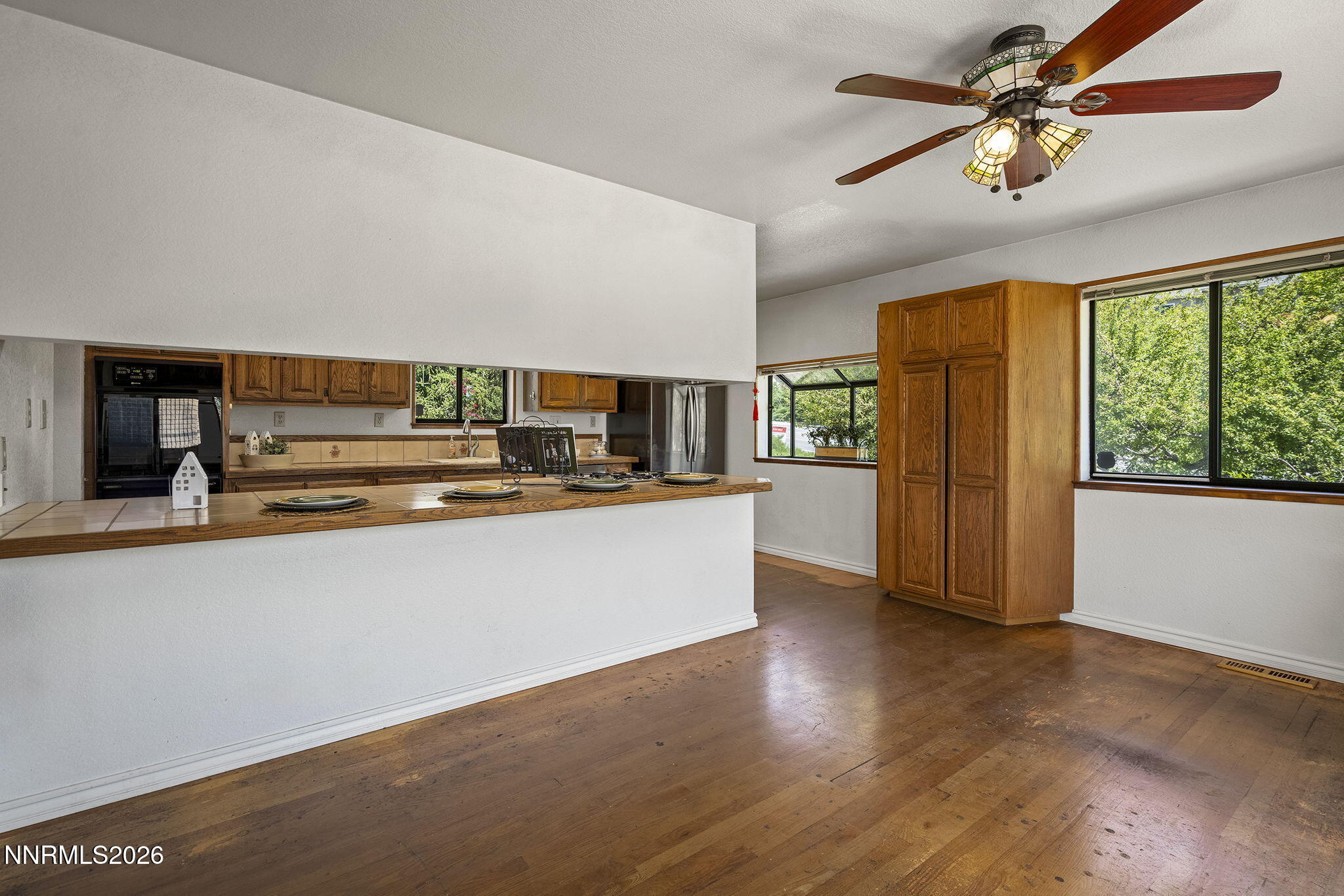 2985 Socrates Drive Reno, NV 89512 - Photo 46 of 52 a living room with stainless steel appliances kitchen island granite countertop a refrigerator a stove a microwave oven with a dining table and chairs