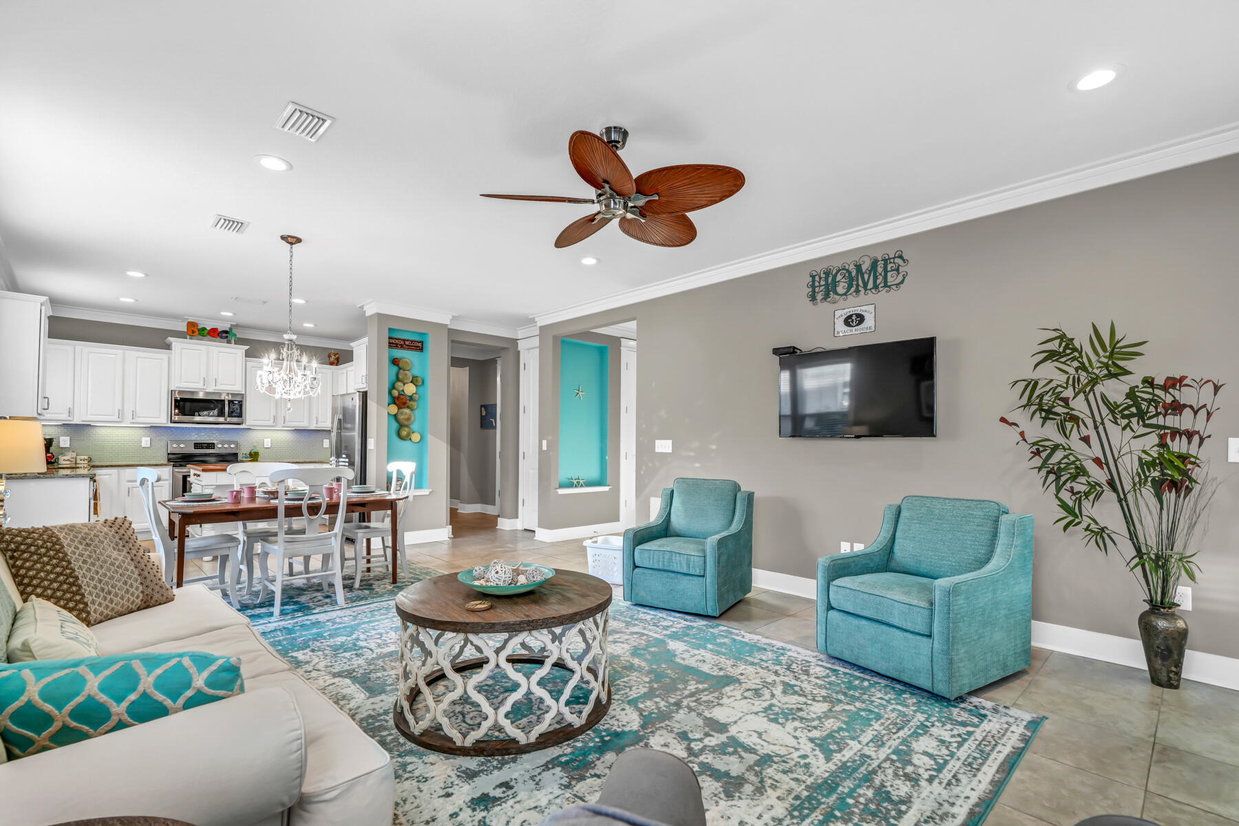 335 Blue Sage Road Panama City Beach, FL 32413 - Photo 13 of 34 a living room with furniture a flat screen tv and kitchen view