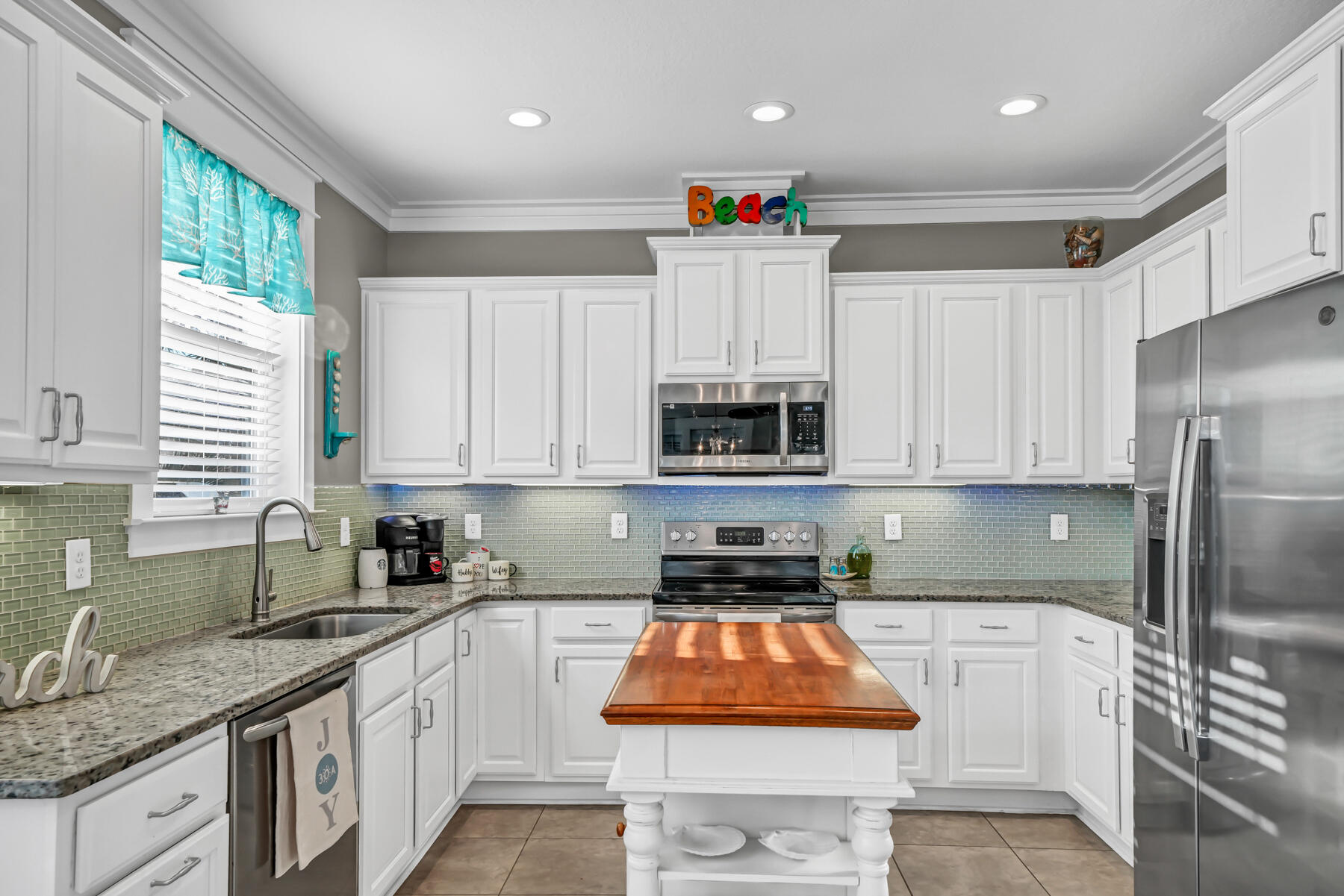 335 Blue Sage Road Panama City Beach, FL 32413 - Photo 14 of 34 a kitchen with stainless steel appliances granite countertop a sink stove and refrigerator