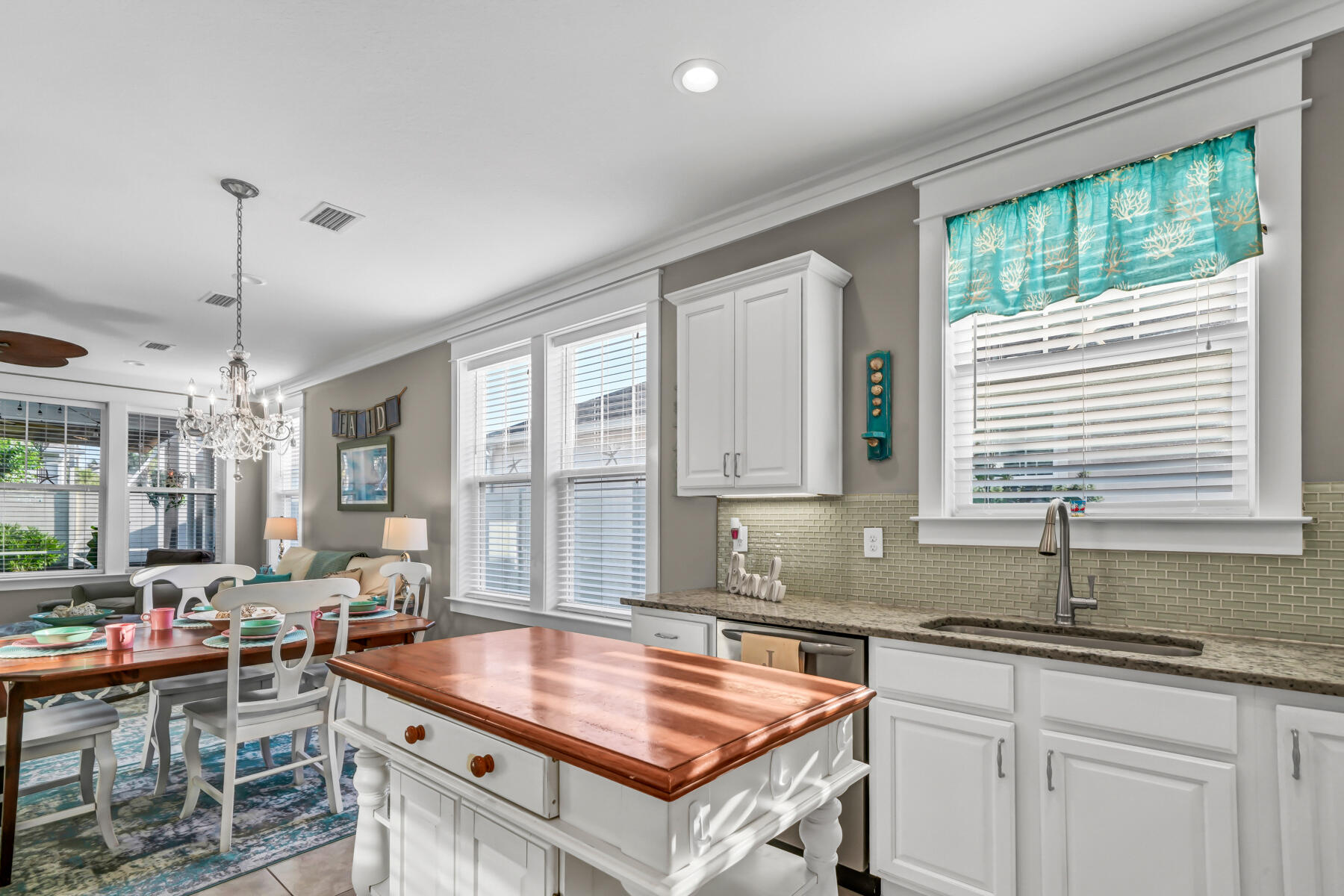 335 Blue Sage Road Panama City Beach, FL 32413 - Photo 15 of 34 a kitchen with stainless steel appliances granite countertop a sink a stove and a wooden floors