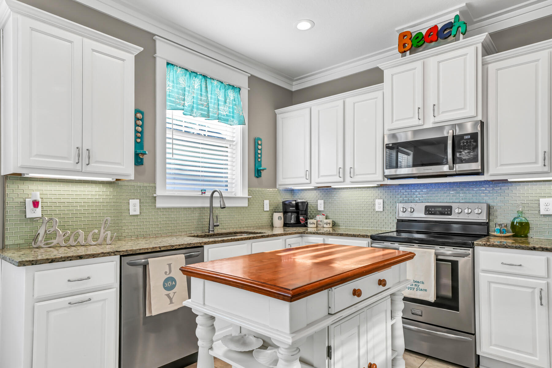 335 Blue Sage Road Panama City Beach, FL 32413 - Photo 16 of 34 a kitchen with stainless steel appliances granite countertop a sink a stove and cabinets