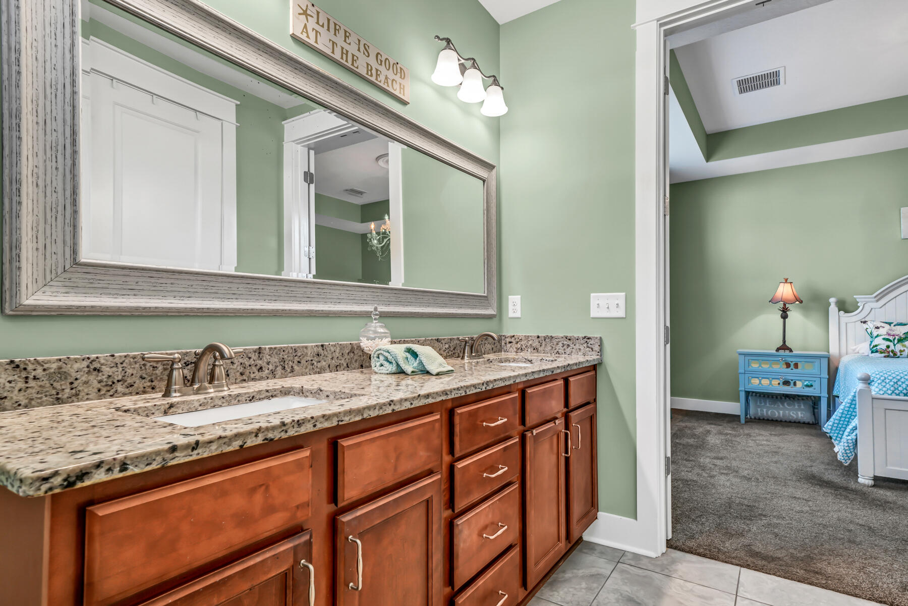 335 Blue Sage Road Panama City Beach, FL 32413 - Photo 20 of 34 a bathroom with a granite countertop sink and a mirror