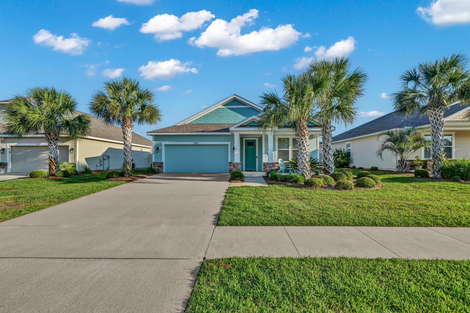 335 Blue Sage Road Panama City Beach, FL 32413 - Photo 2 of 34 a front view of a house with a garden