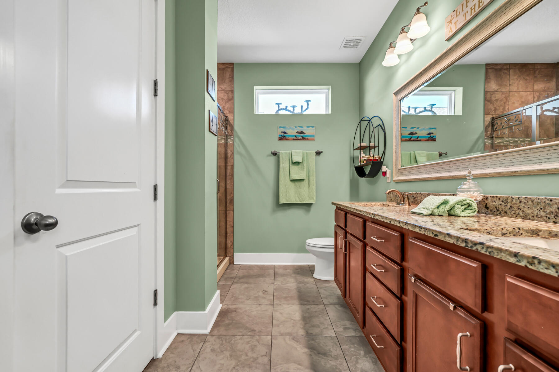 335 Blue Sage Road Panama City Beach, FL 32413 - Photo 21 of 34 a bathroom with a sink a mirror and a shower