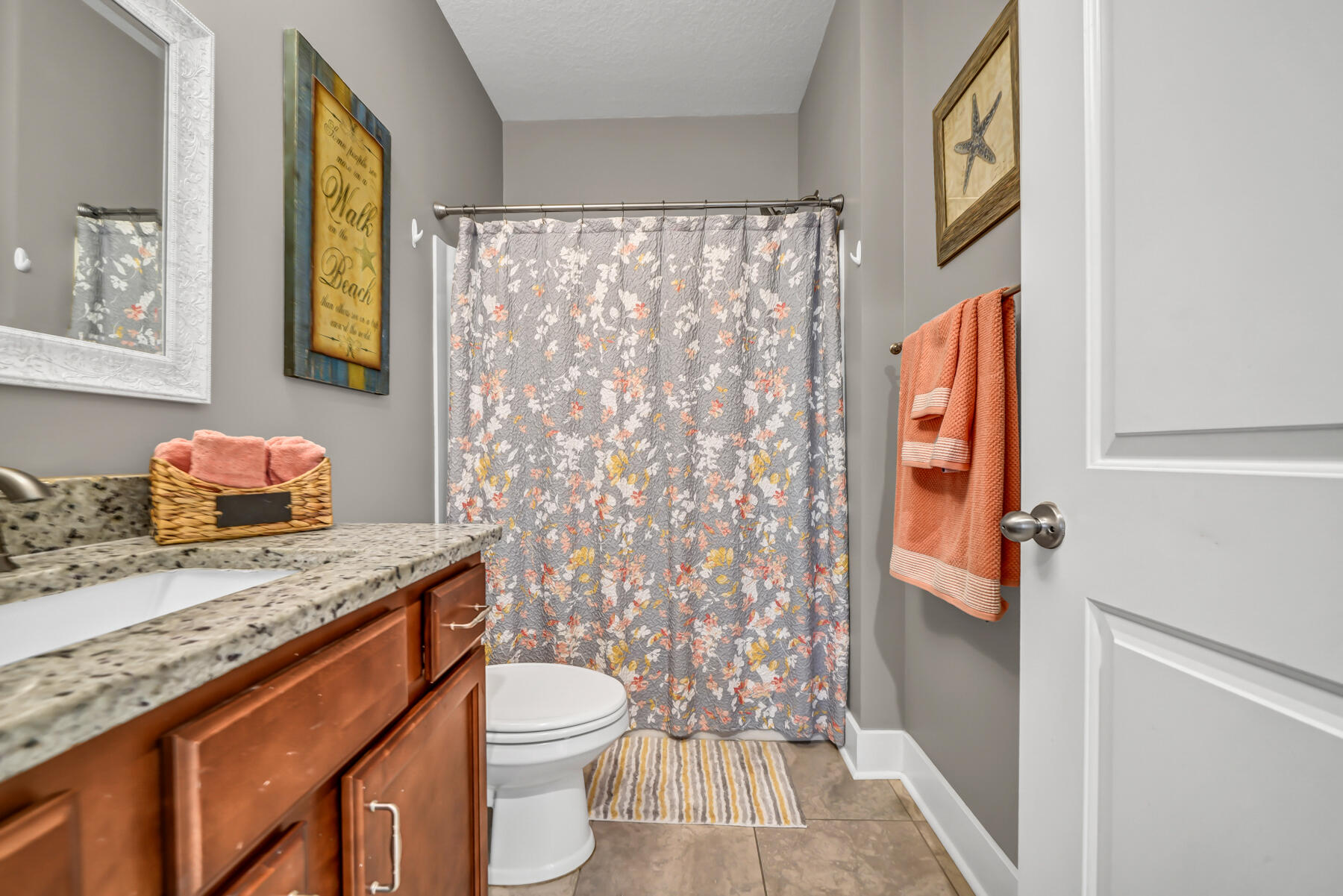 335 Blue Sage Road Panama City Beach, FL 32413 - Photo 24 of 34 a bathroom with a granite countertop sink toilet and shower curtains