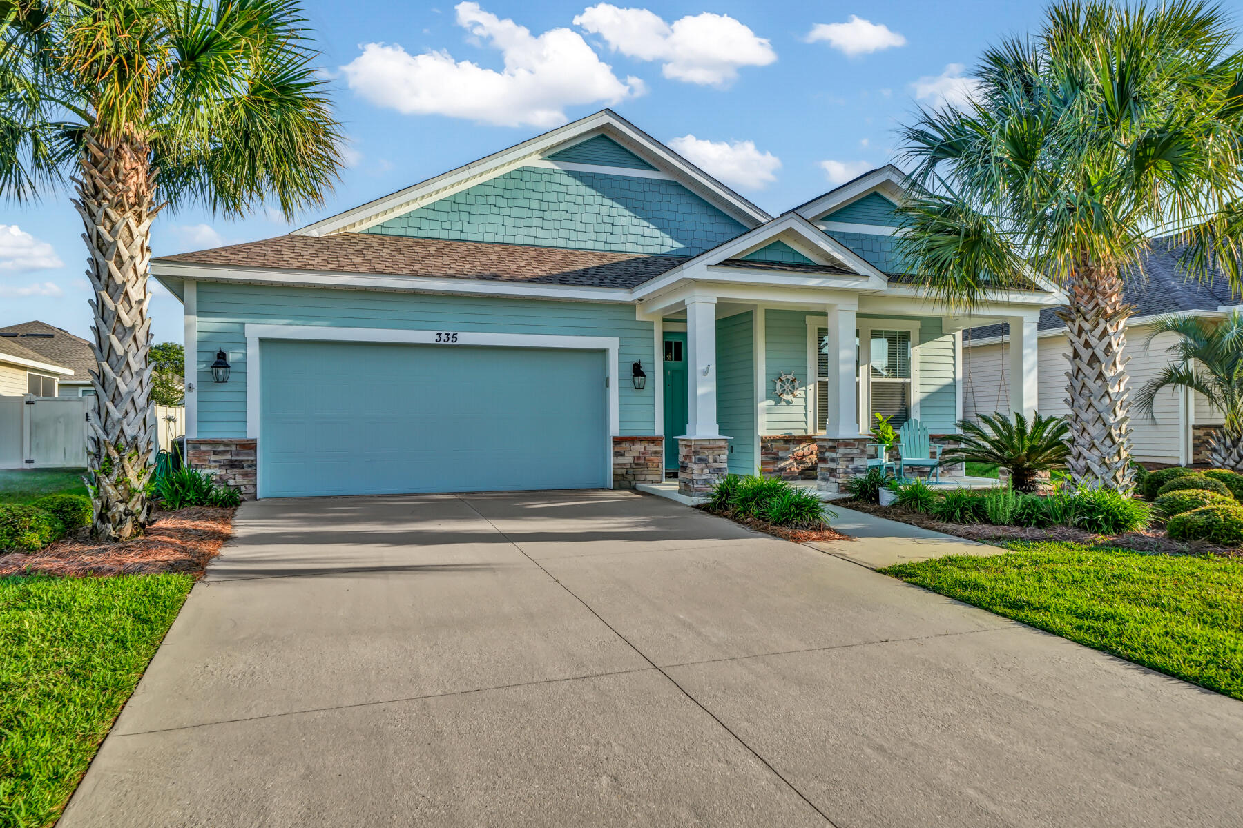 335 Blue Sage Road Panama City Beach, FL 32413 - Photo 3 of 34 a front view of a house with garden