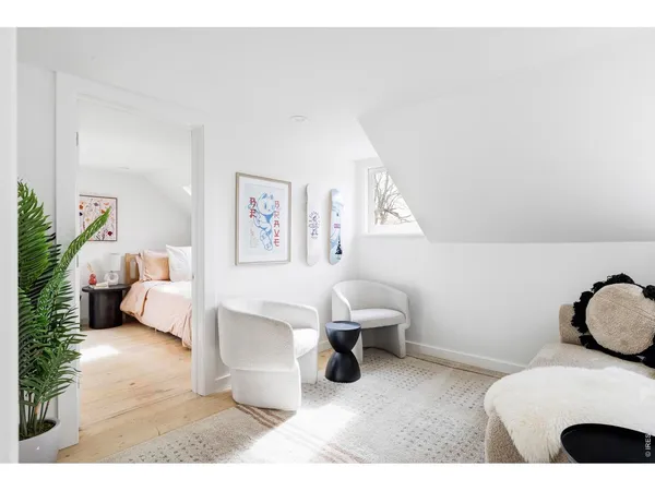 a bedroom with furniture and a large window