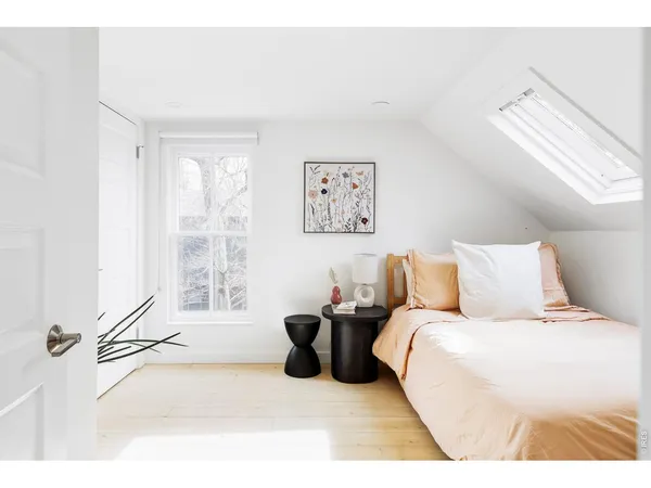 a bedroom with a bed and a large window