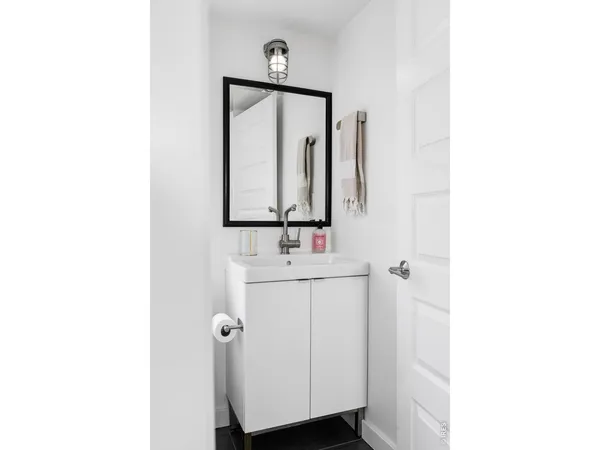 a bathroom with a sink a mirror and vanity