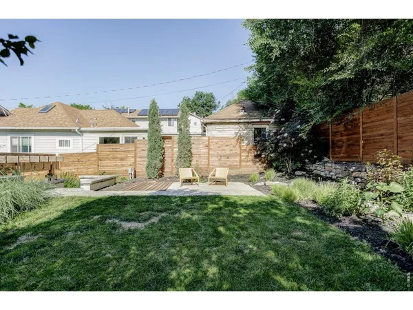 a view of a house with a yard and sitting area