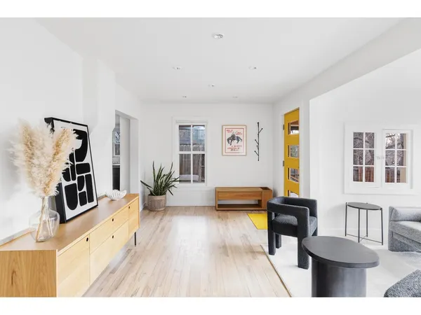 a living room with furniture and a wooden floor