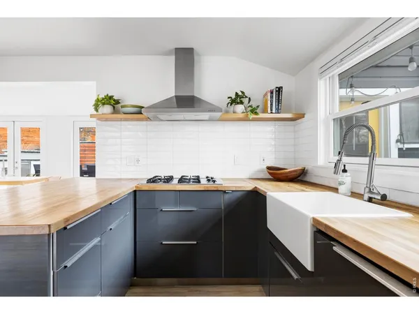 a kitchen with a sink a stove and cabinets