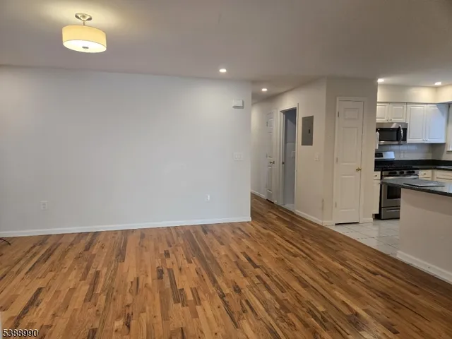 a view of kitchen with wooden floor and electronic appliances