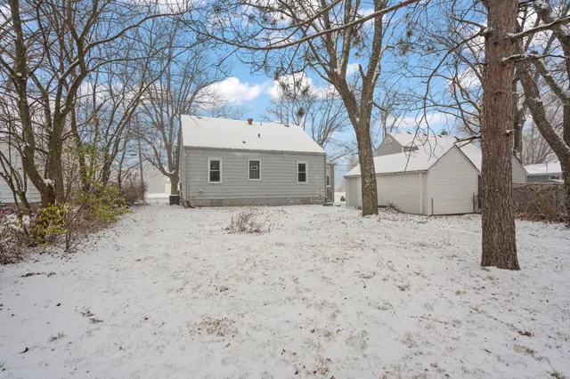 a view of a house with a snow in the yard