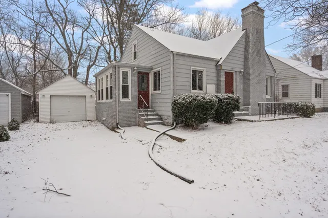 a view of a house with a snow in the yard