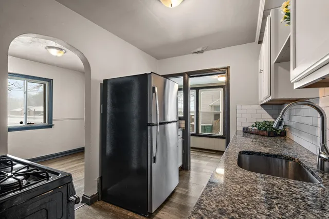 a kitchen with a refrigerator and a sink