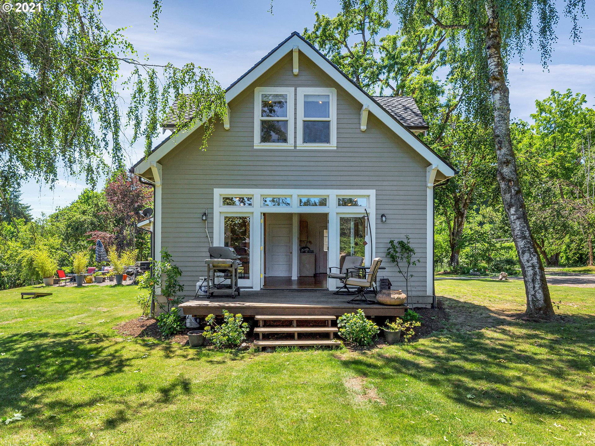 16096 Southwest Wilsonville Road Wilsonville, OR 97070 - Photo 28 of 32 a front view of a house with a yard table and chairs