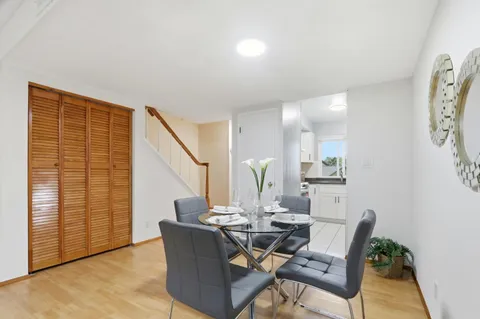 a dining room with furniture and wooden floor