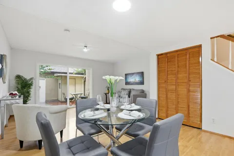 a view of a dining room with furniture and wooden floor