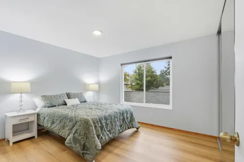 a bedroom with a bed and a window