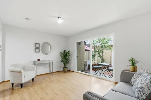 a living room with furniture a lamp and a large window