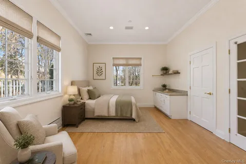 a bedroom with a bed and a large window