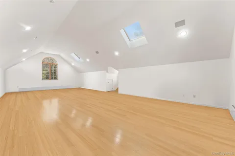 a view of big room with wooden floor and windows