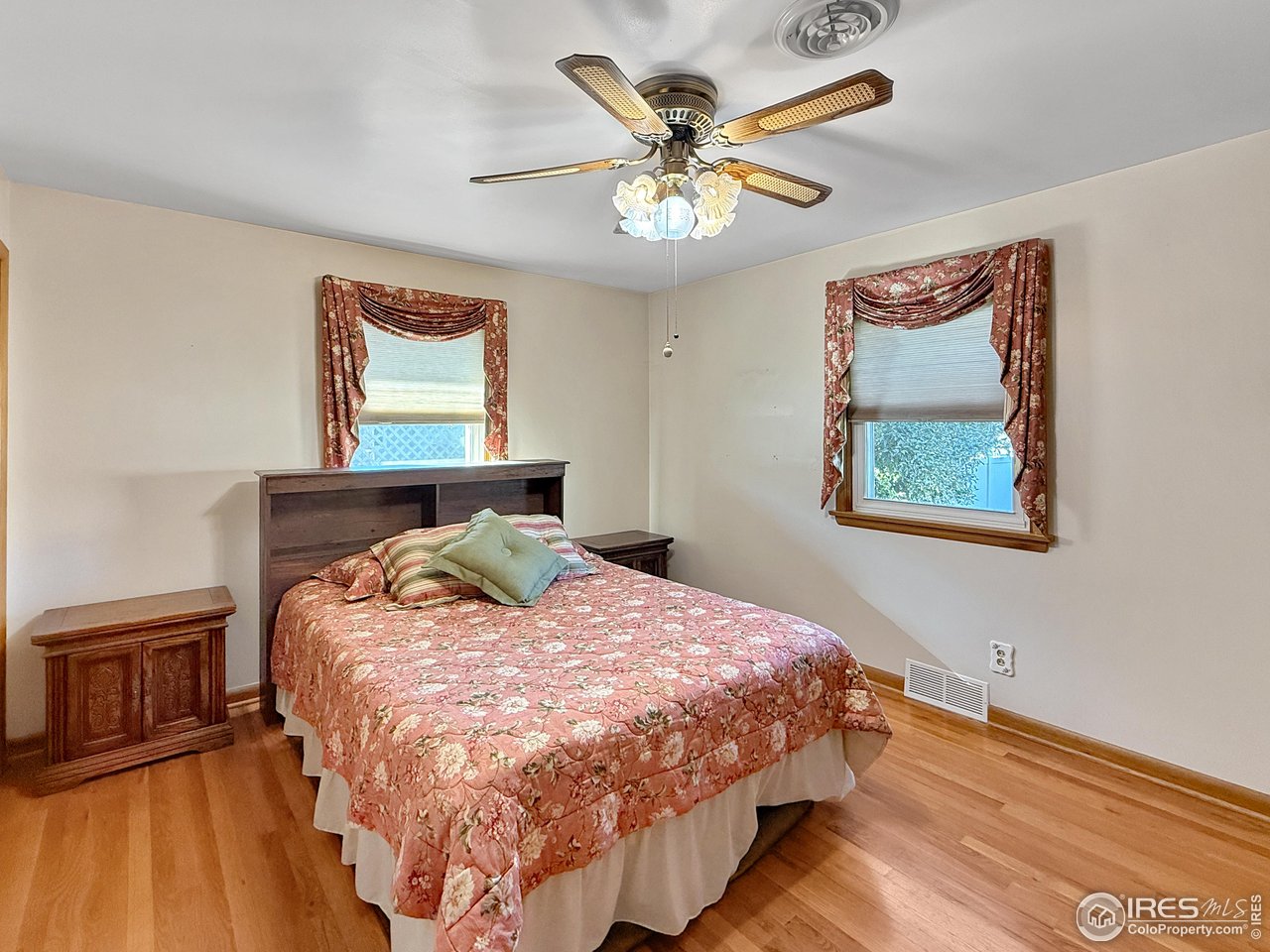 508 Fairhurst Street Sterling, CO 80751 - Photo 12 of 39 a bedroom with a bed and a chandelier