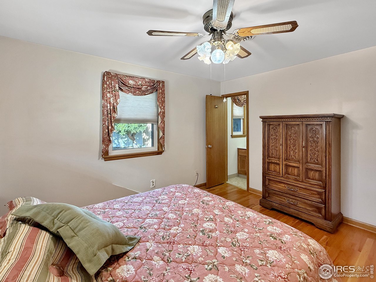 508 Fairhurst Street Sterling, CO 80751 - Photo 13 of 39 a bedroom with a bed and a chandelier