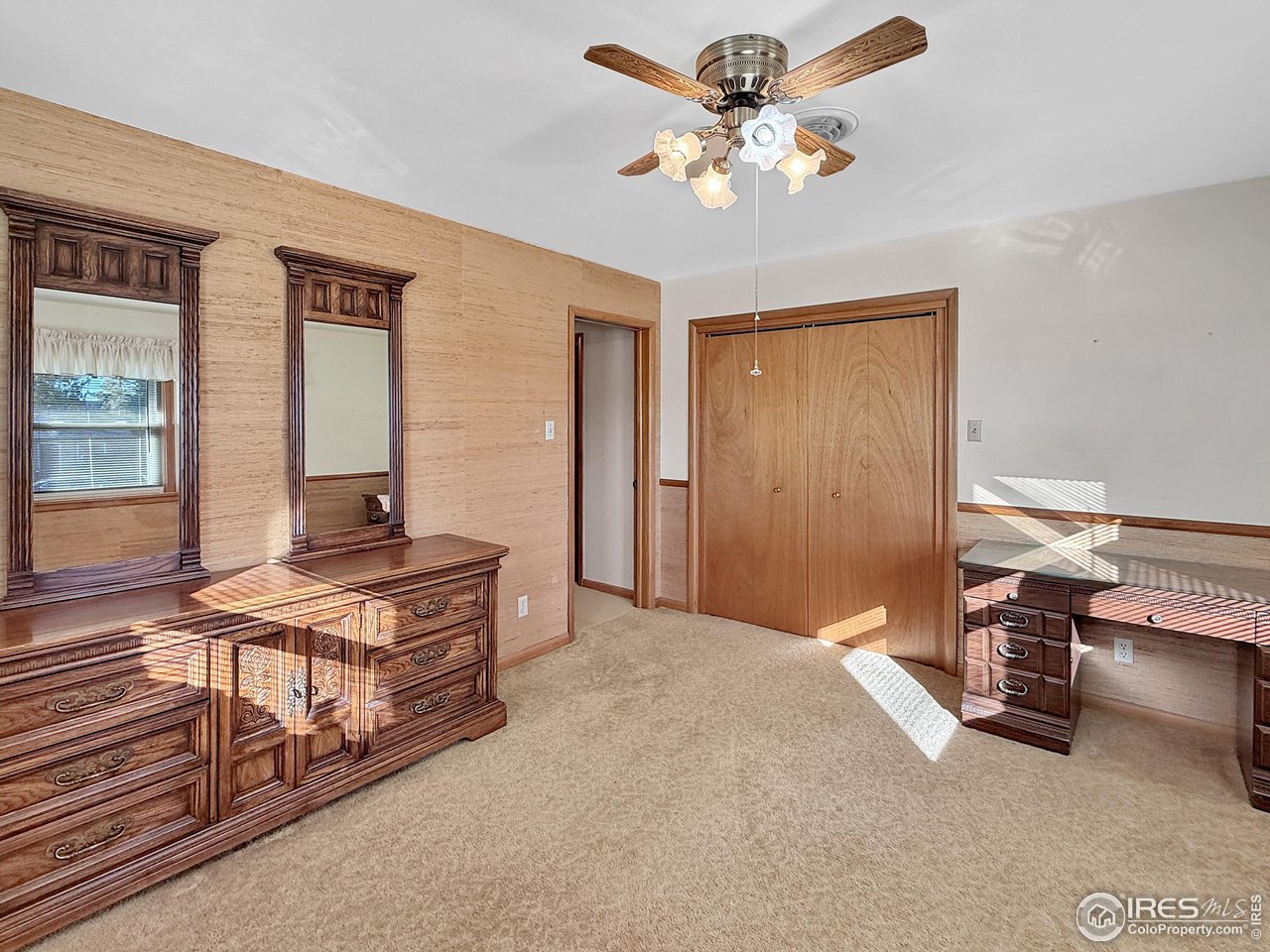 508 Fairhurst Street Sterling, CO 80751 - Photo 20 of 39 a bedroom with a bed and a chandelier