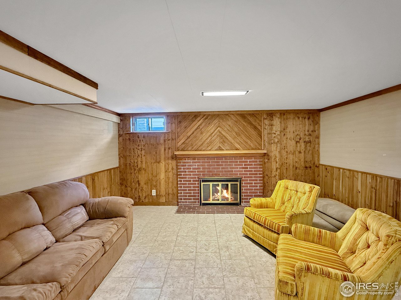 508 Fairhurst Street Sterling, CO 80751 - Photo 26 of 39 a living room with furniture and a fireplace