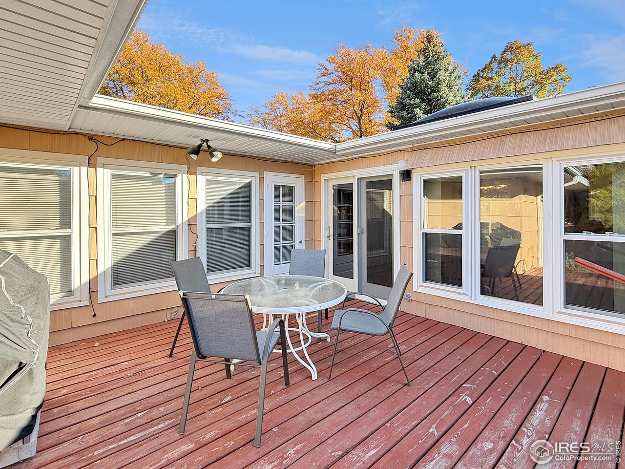 508 Fairhurst Street Sterling, CO 80751 - Photo 34 of 39 a balcony with wooden floor table and chairs