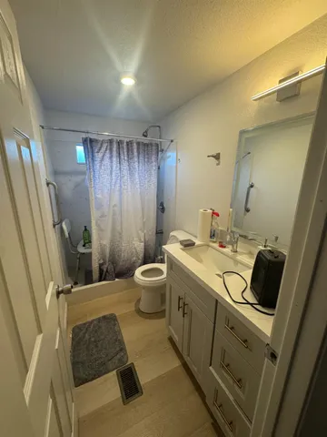a bathroom with a sink toilet and shower