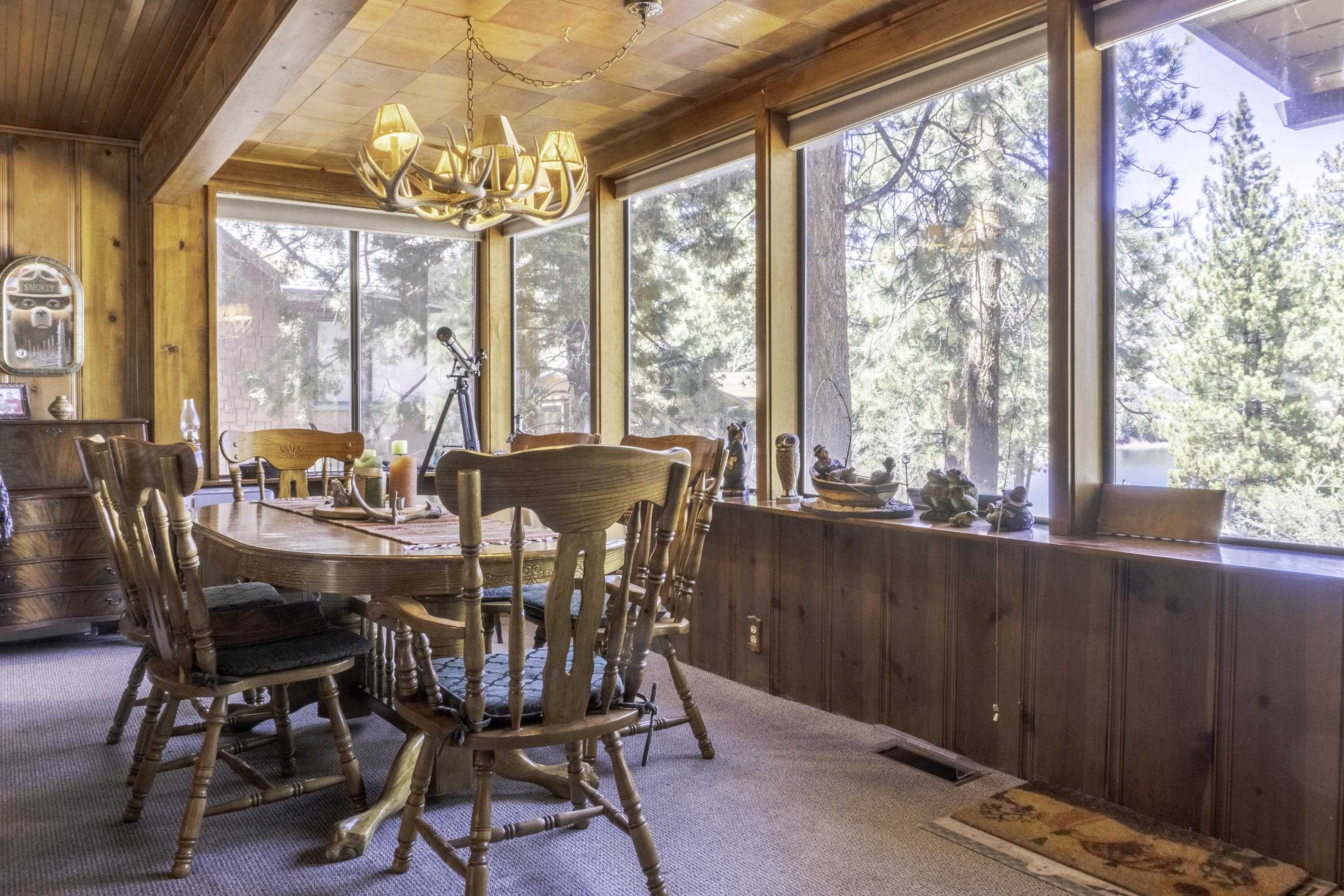 64 Frst Knl Road, Unit 47 June Lake, CA 93529 - Photo 2 of 34 a view of a dining room with furniture large windows and wooden floor