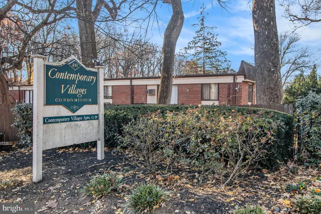 a view of a house with a yard and garden