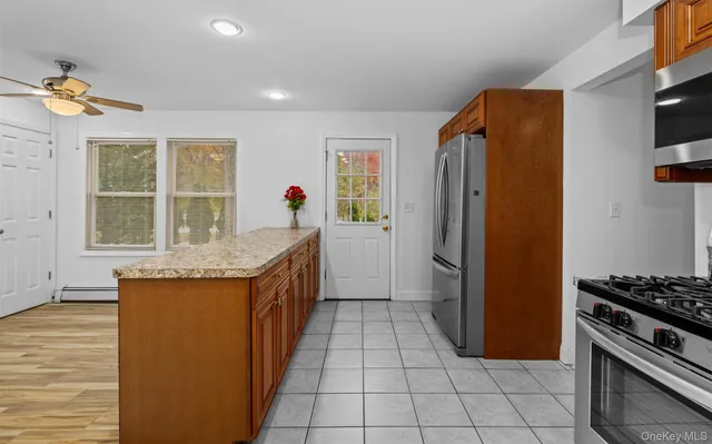 a kitchen with stainless steel appliances granite countertop a refrigerator and a stove