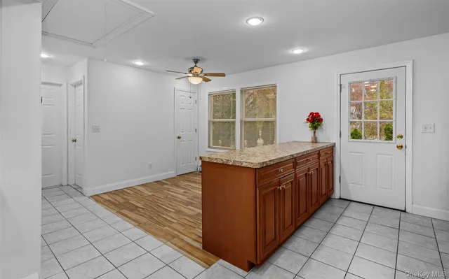 a kitchen with granite countertop a sink and a stove