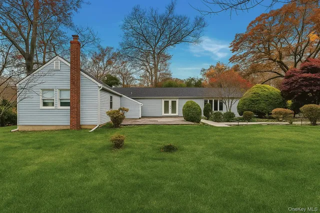 a front view of house with a garden