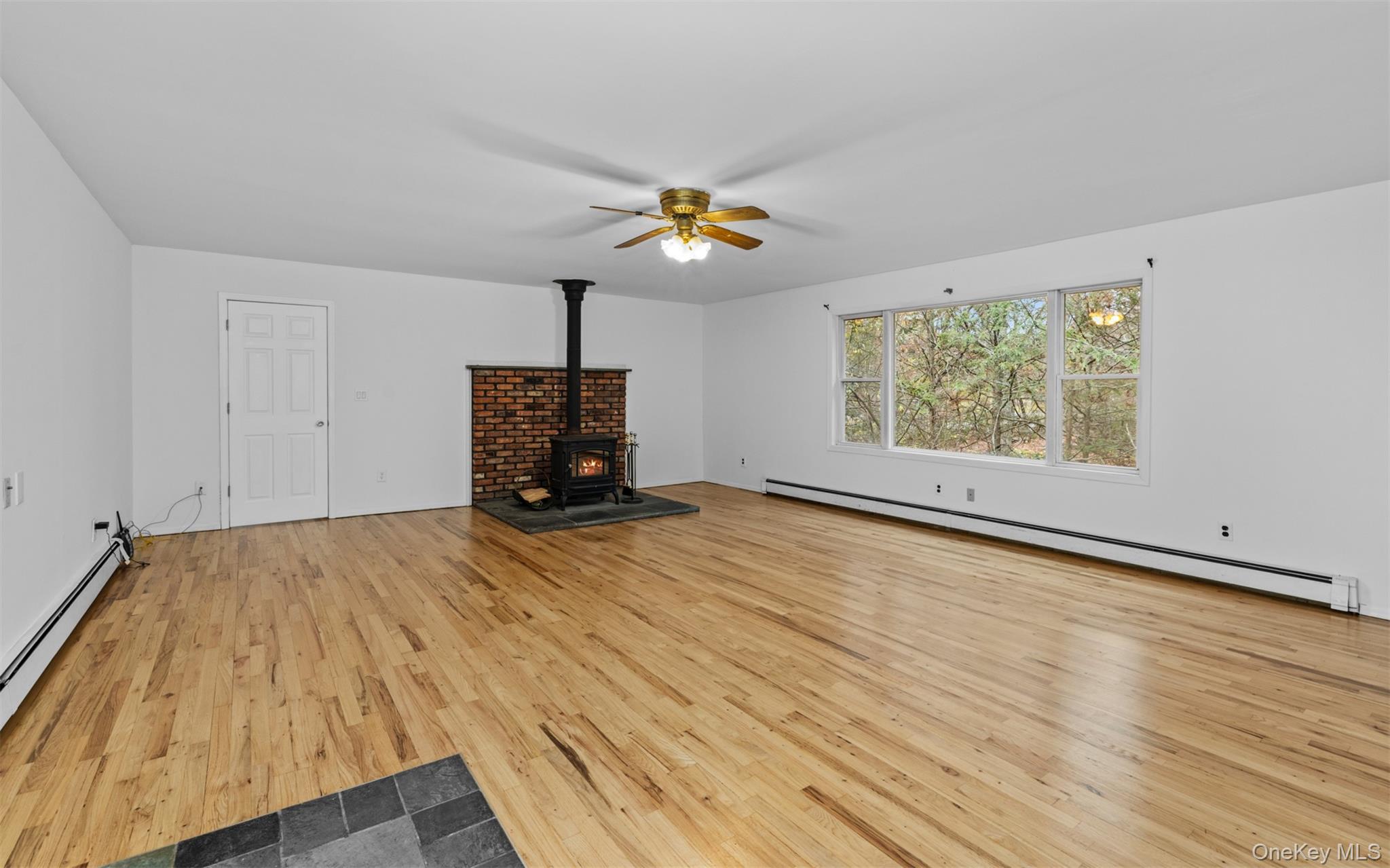 37 Pond Lane Ridge, NY 11961 - Photo 7 of 26 wooden floor in an empty room with a window