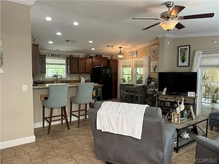 a living room with dining room furniture and a flat screen tv